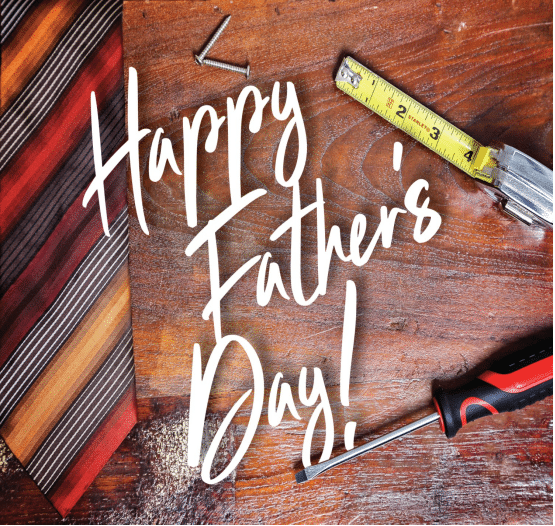 On a wood tabletop, we see a striped tie in autumn colors at right. To the left are some screws, a tape measure, and a screwdriver with a red and black handle. In the center "Happy Father's Day!" is written in white in a handwriting script.